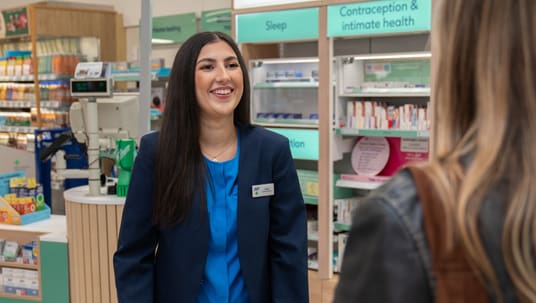 Two female pharmacists are talking to each other in Boots Pharmacy