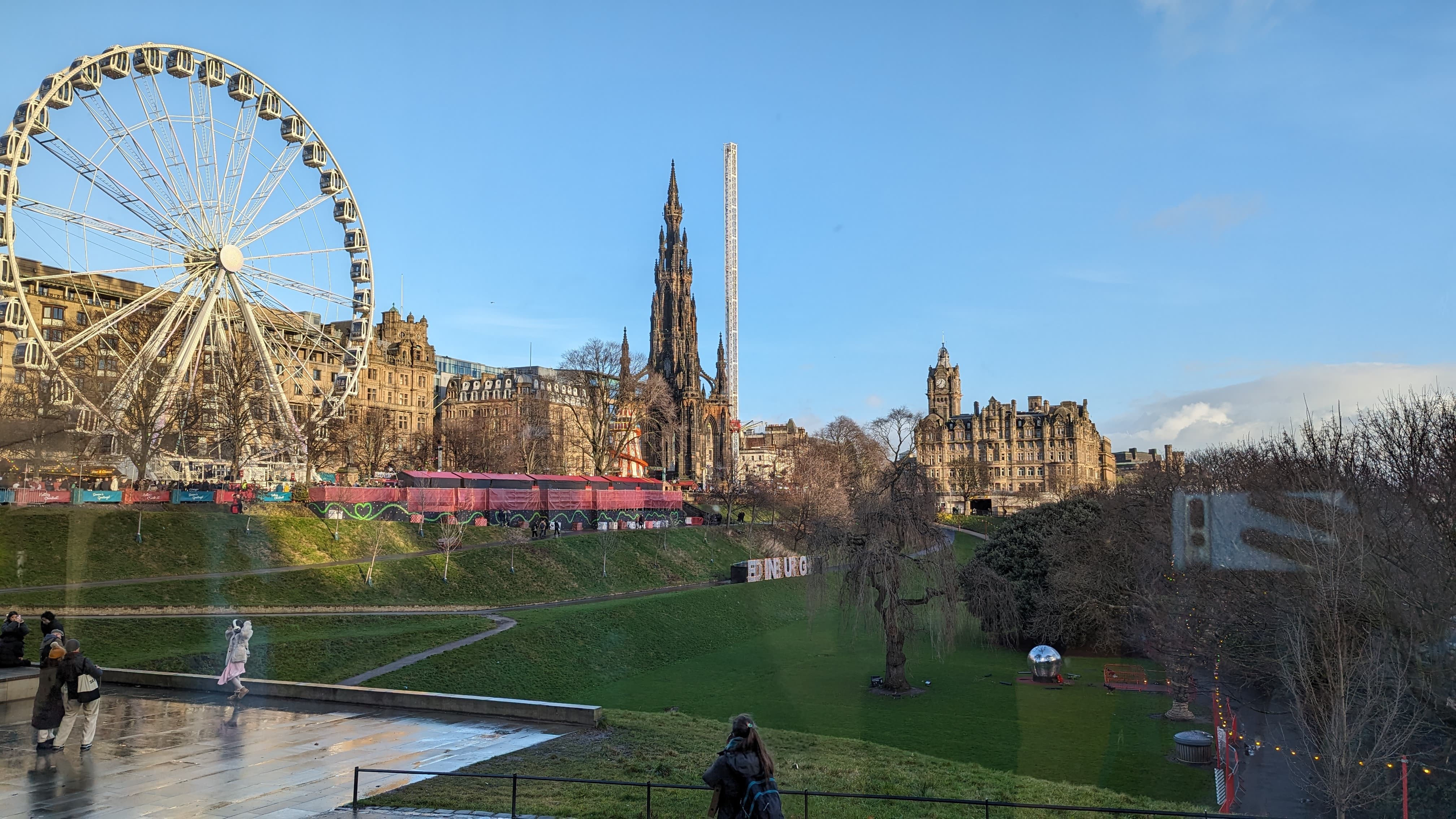A photo of Edinburgh shows blue skies and historic buildings
