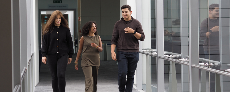 Three graduate employees walking in the Boots support office lobby